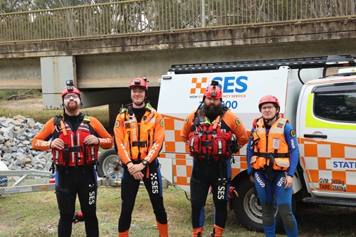 SES members in wetsuits in front of SES vehicle