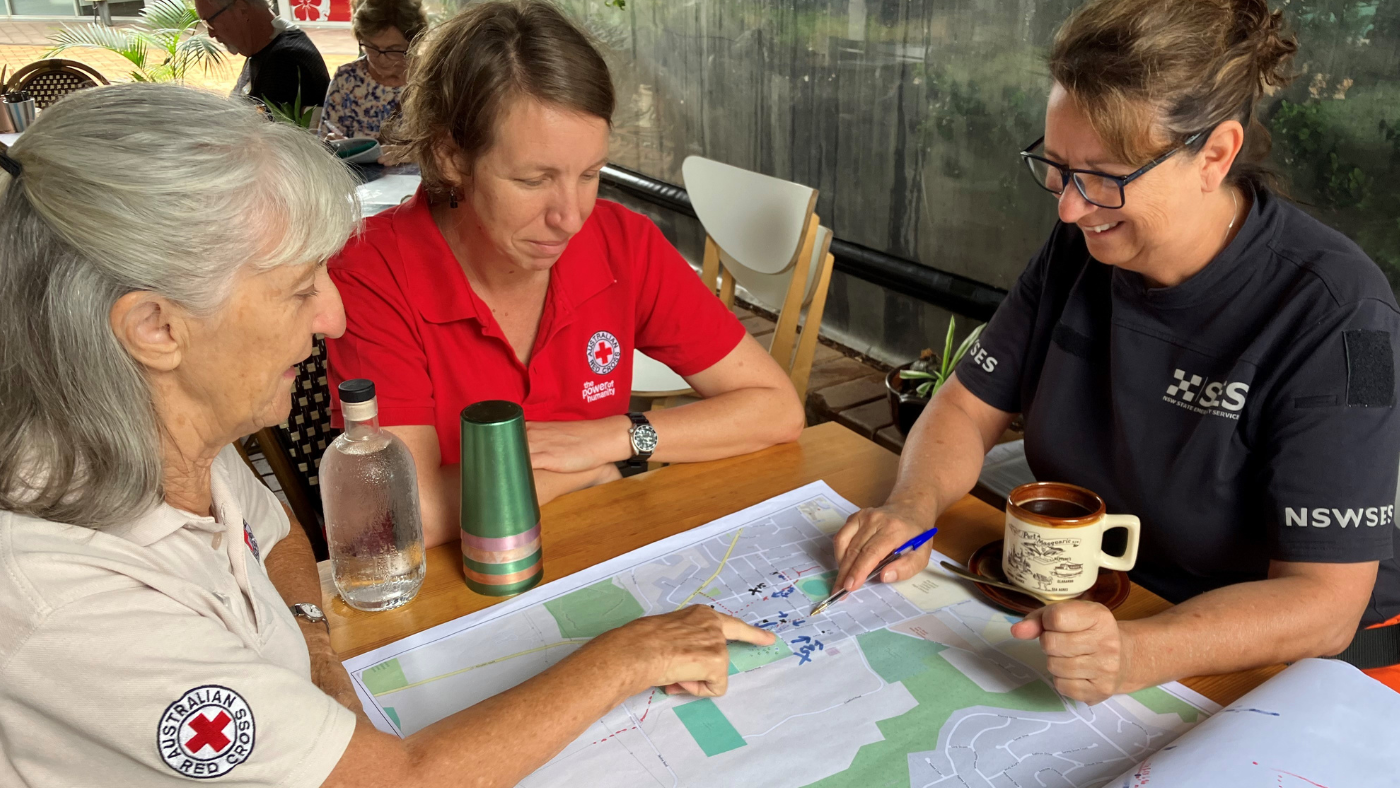 Three ladies looking at a map and pointing
