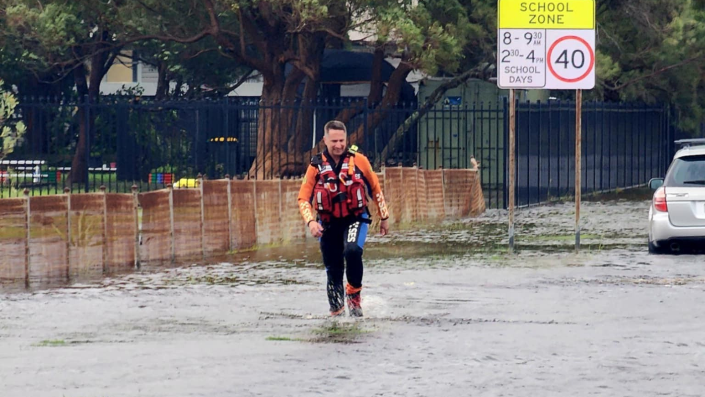 Flood rescue operator walking through flood water