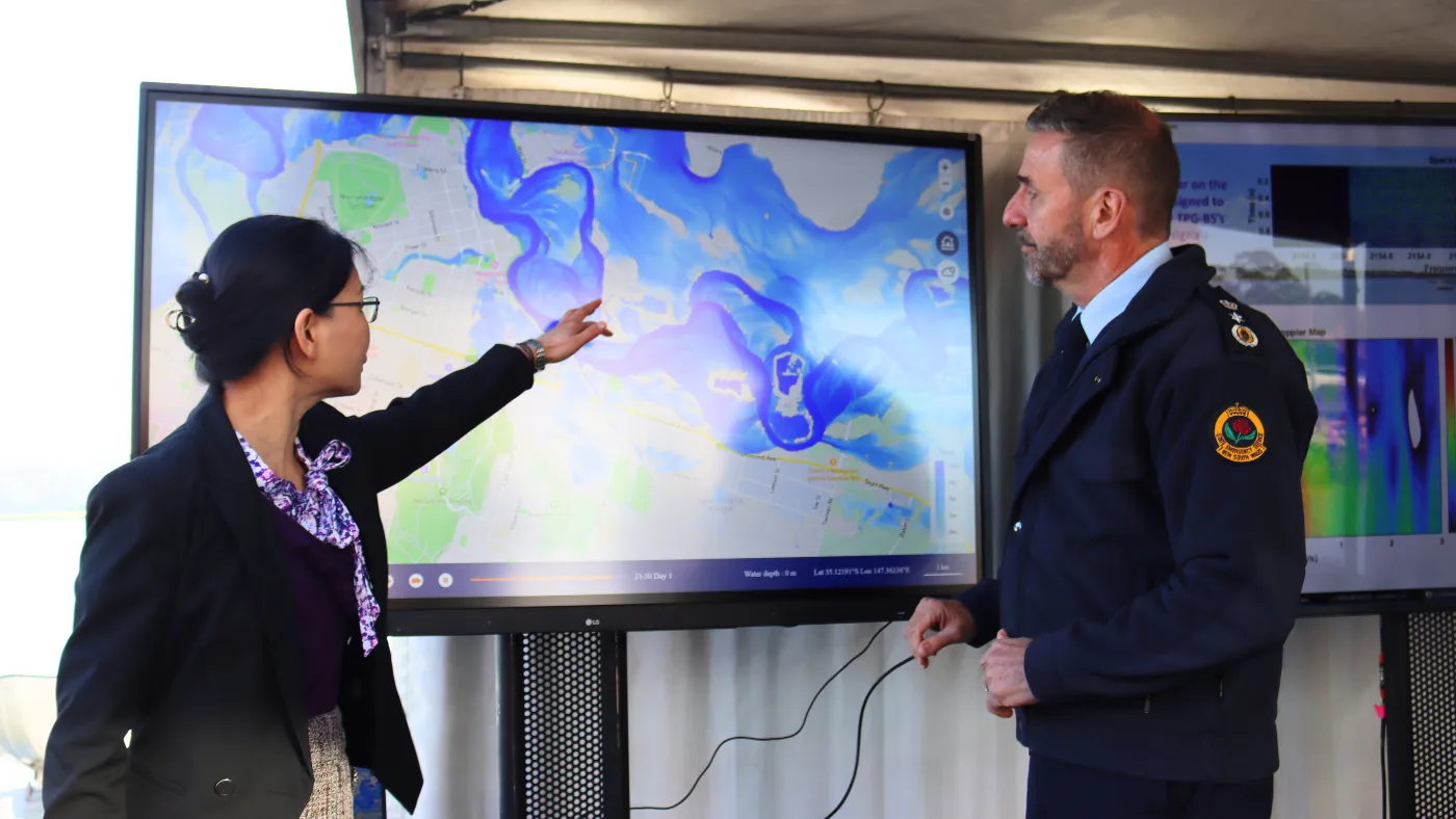 The commissioner and UTS student demonstrating the flood sensing project