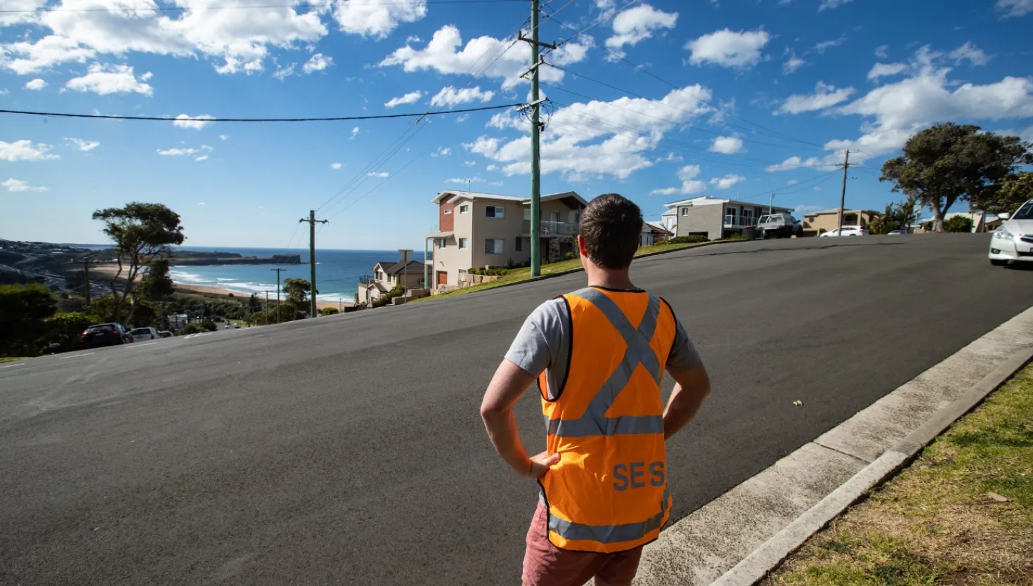 NSW SES Volunteer observing a coastal erosion.