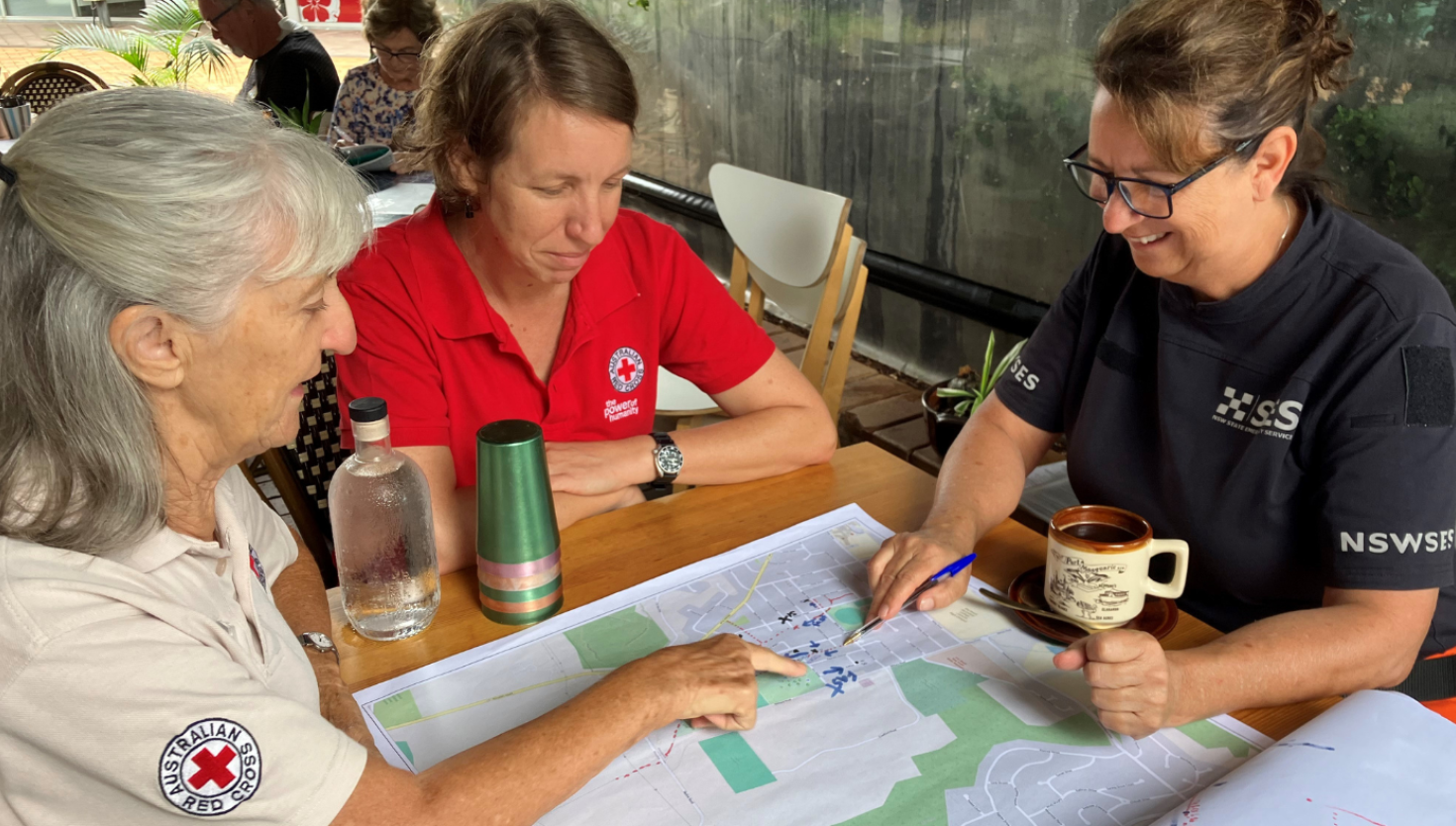 Three ladies looking at a map and pointing