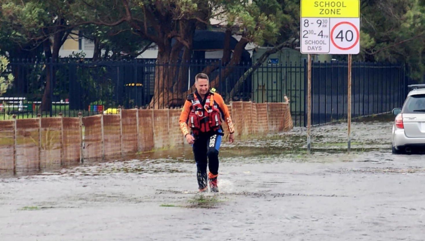 Flood rescue operator walking through flood water