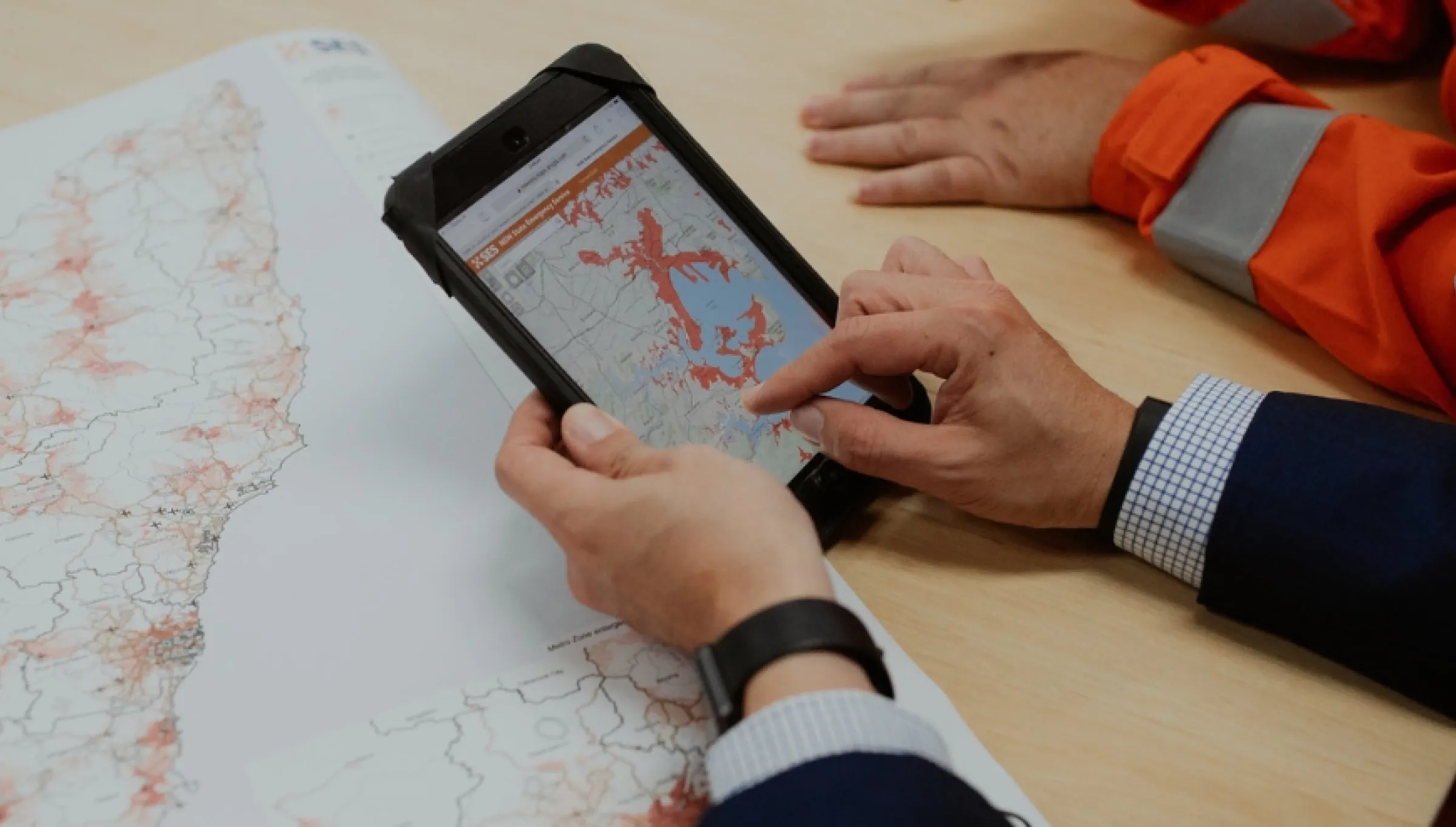 Person scrolling through an NSW SES zones map on a tablet.