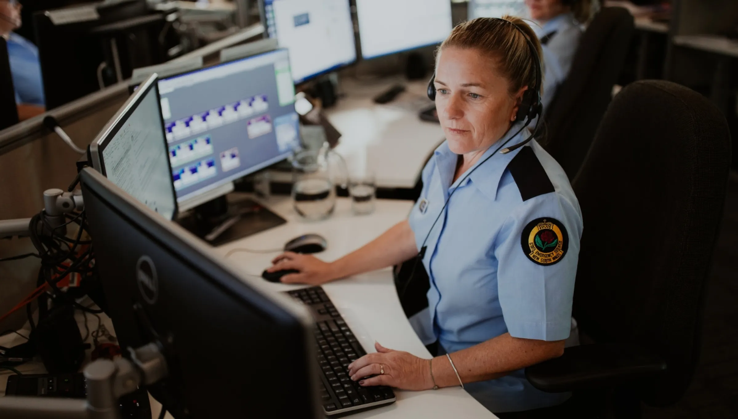 Female worker using a computer at the NSW SES Operations Centre.