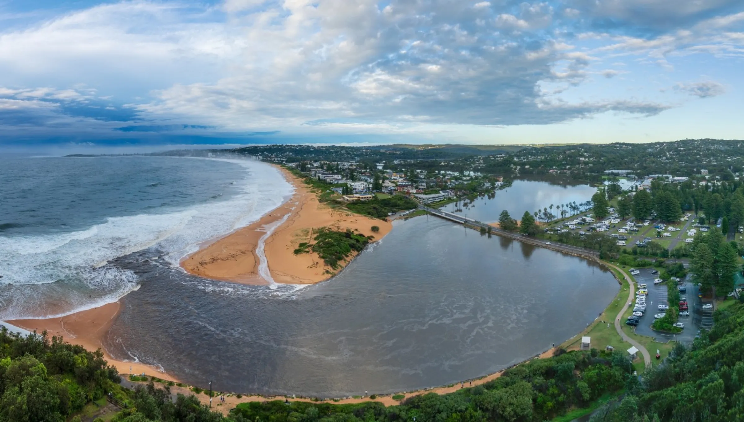 Aerial view of the Narrabeen Lagoon meeting the ocean in Narrabeen, NSW.