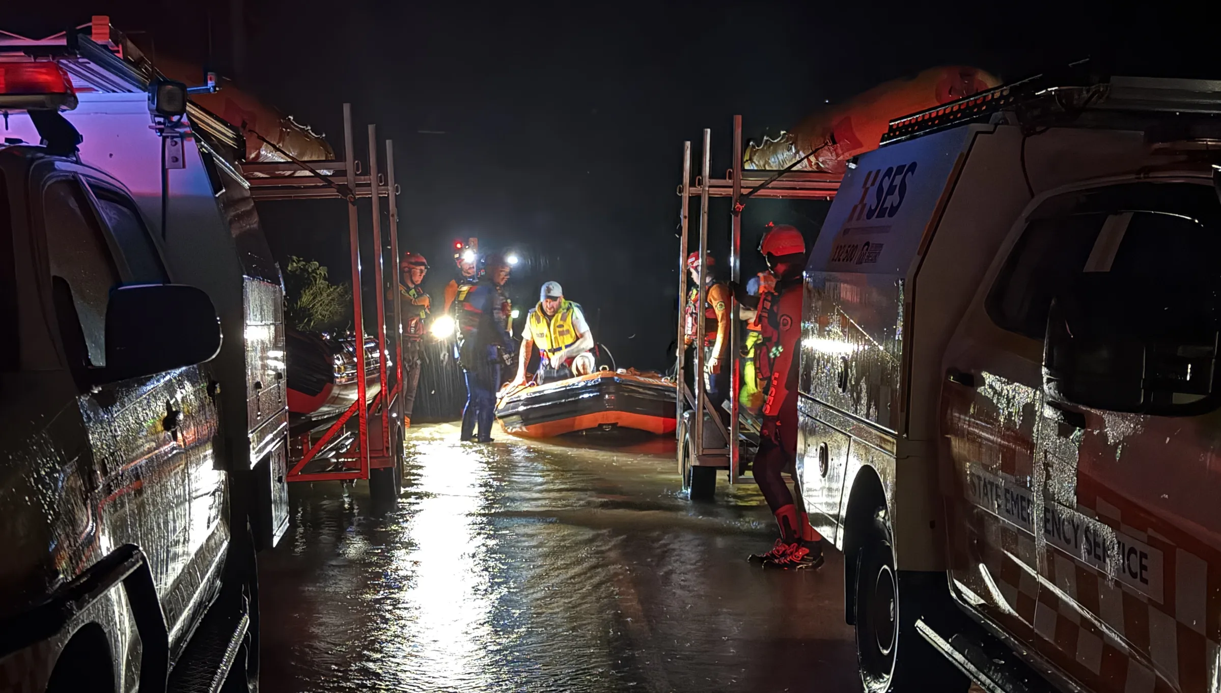 Flood rescue with vehicles on either side on dry land