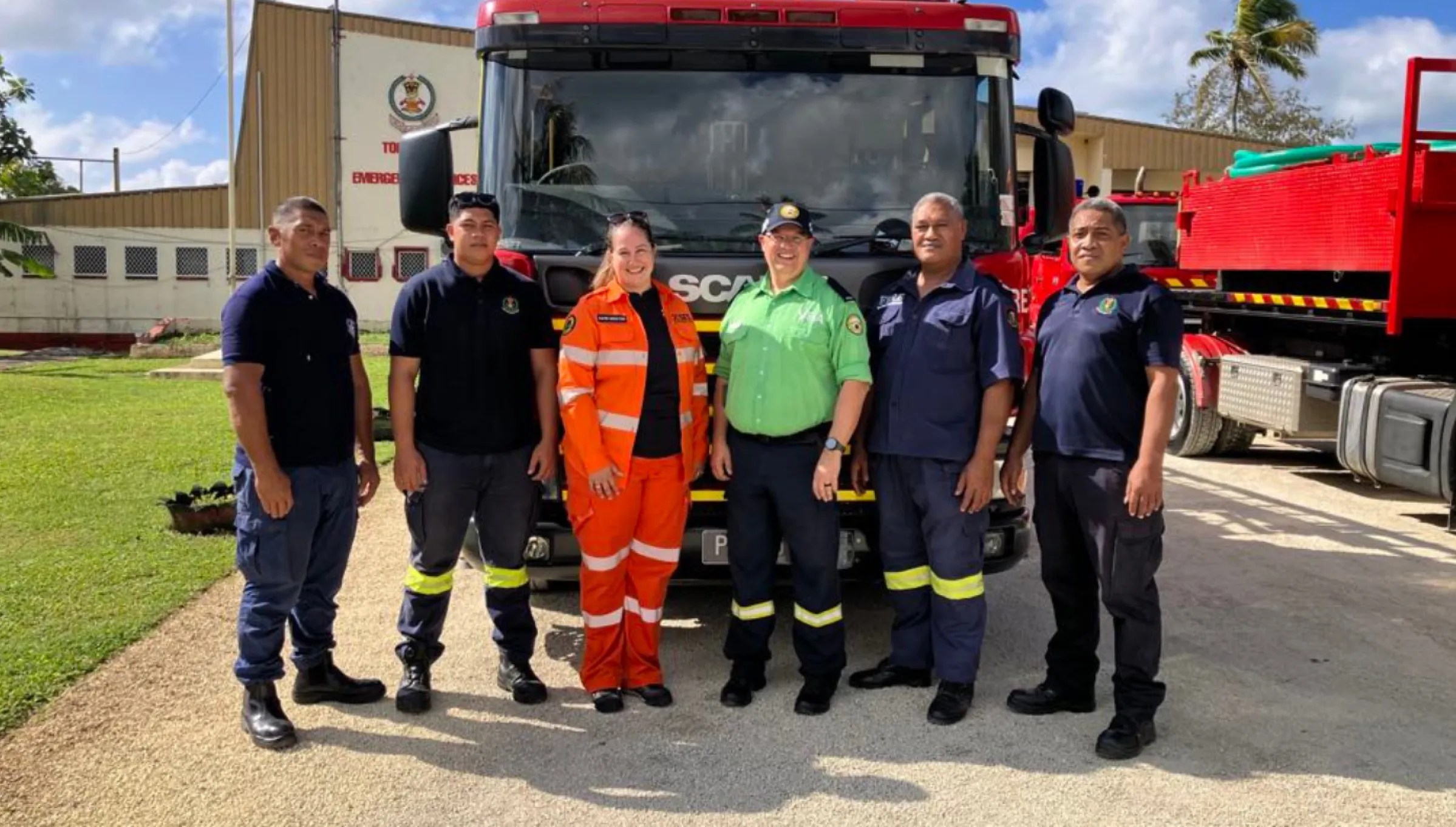 6 people standing in front of a truck in Tonga