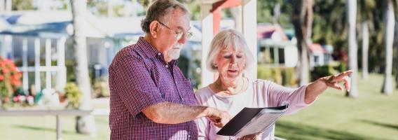 Two community members of the Hunter Valley region looking at flood risk documentation.
