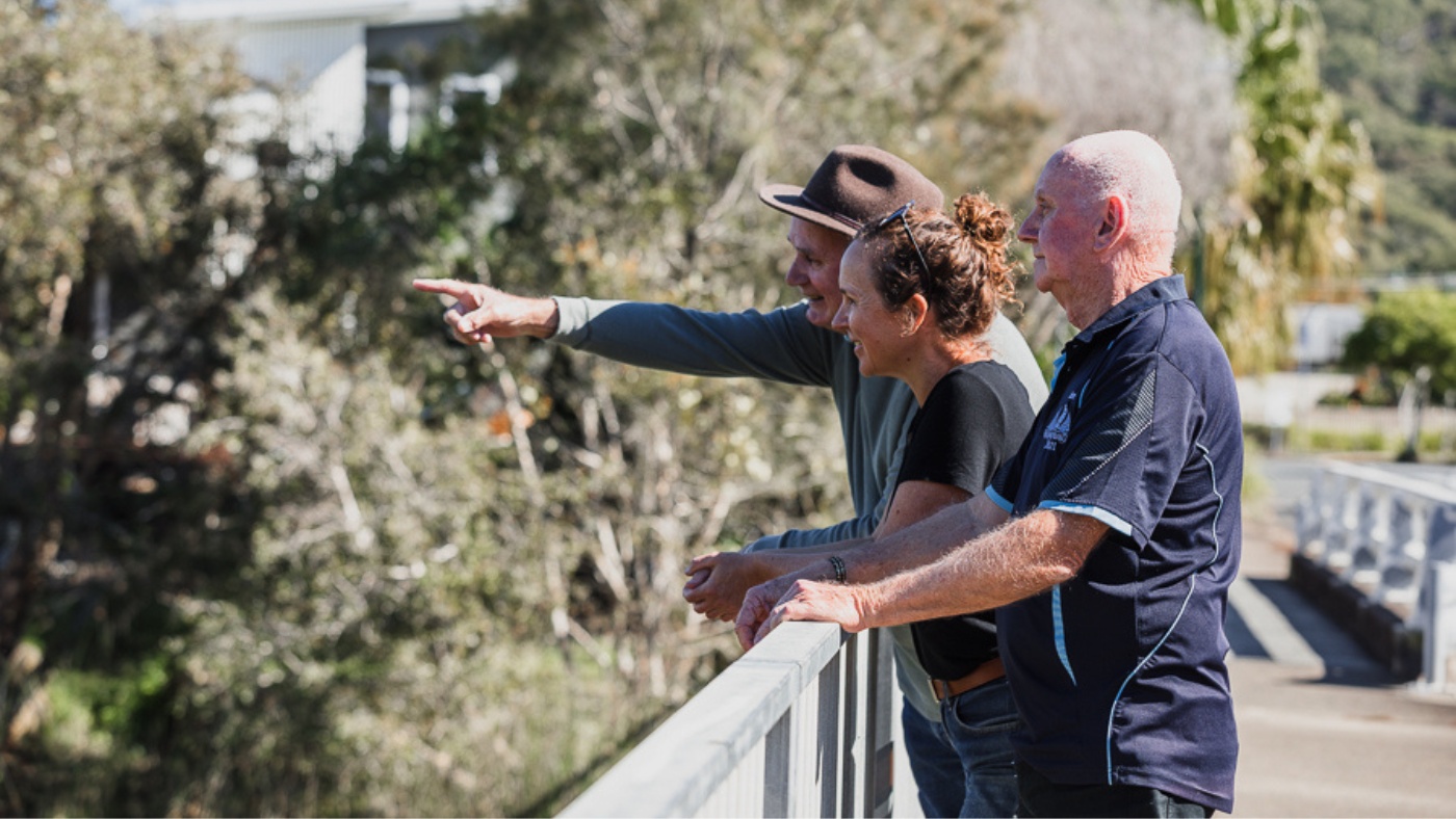 Community members look out to river